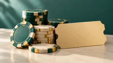 Emerald and ivory gaming chips on a green table